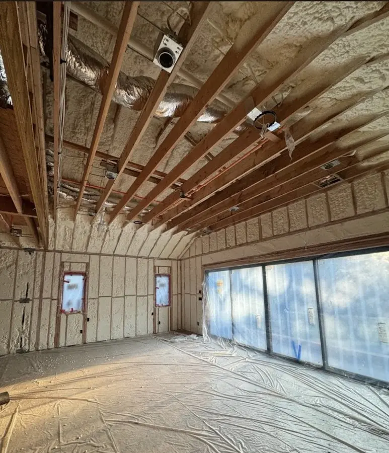 Interior walls and ceiling insulated with spray foam during new construction in Manchester